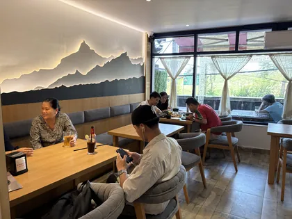 The mountain artwork and moon light above the seating area
